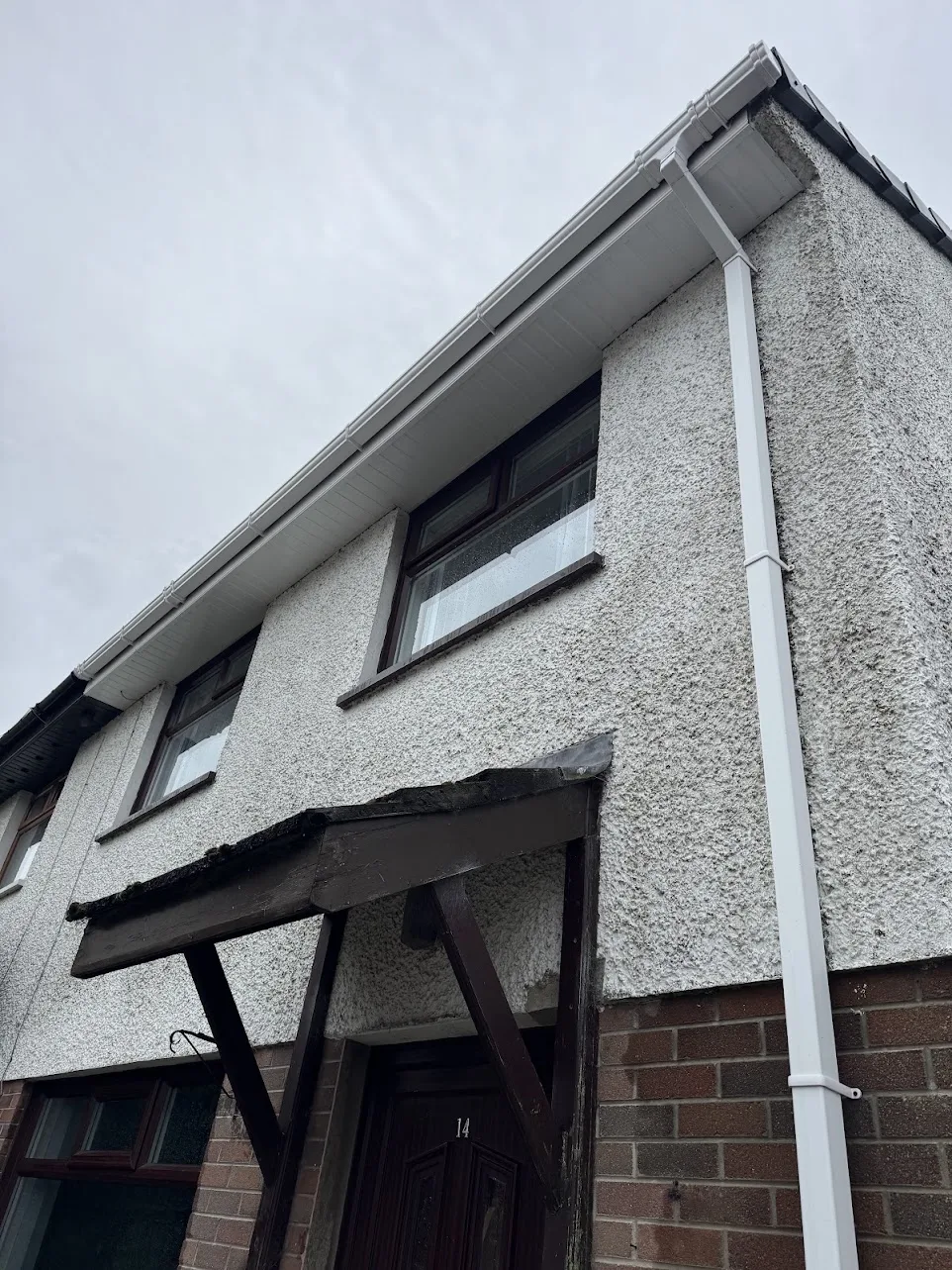 Clean white soffits, fascias, gutters and downpipe after cleaning