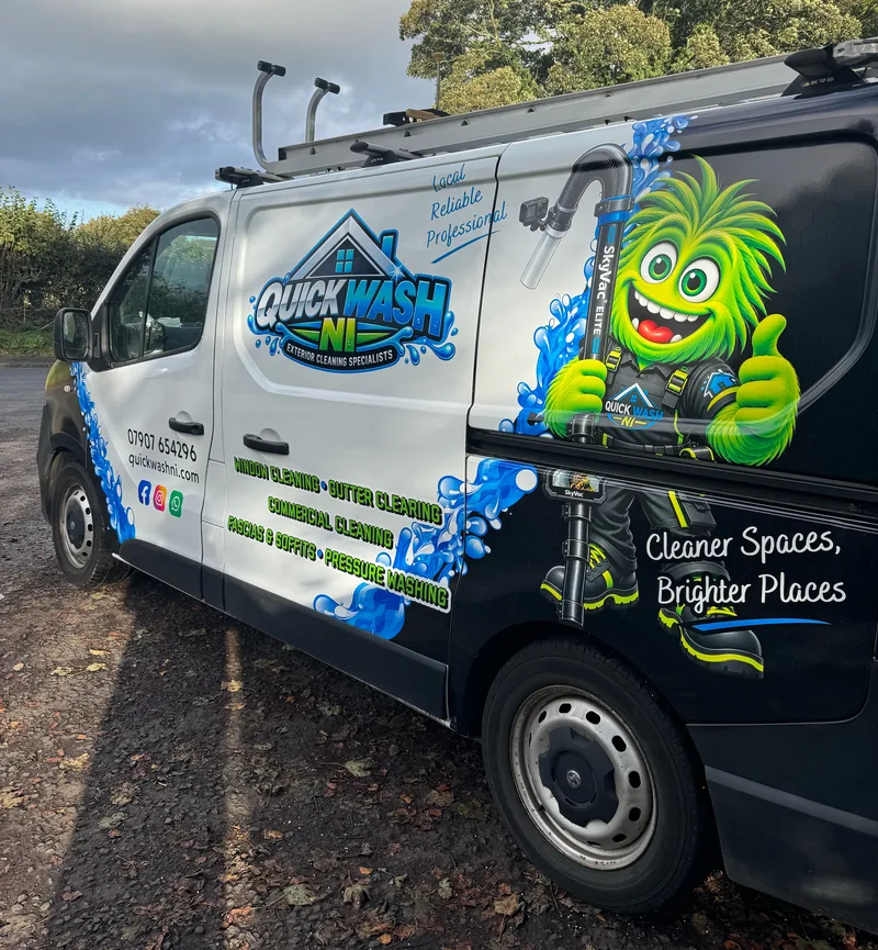 Side of the QuickWash NI van with the green monster holding a SkyVac pole